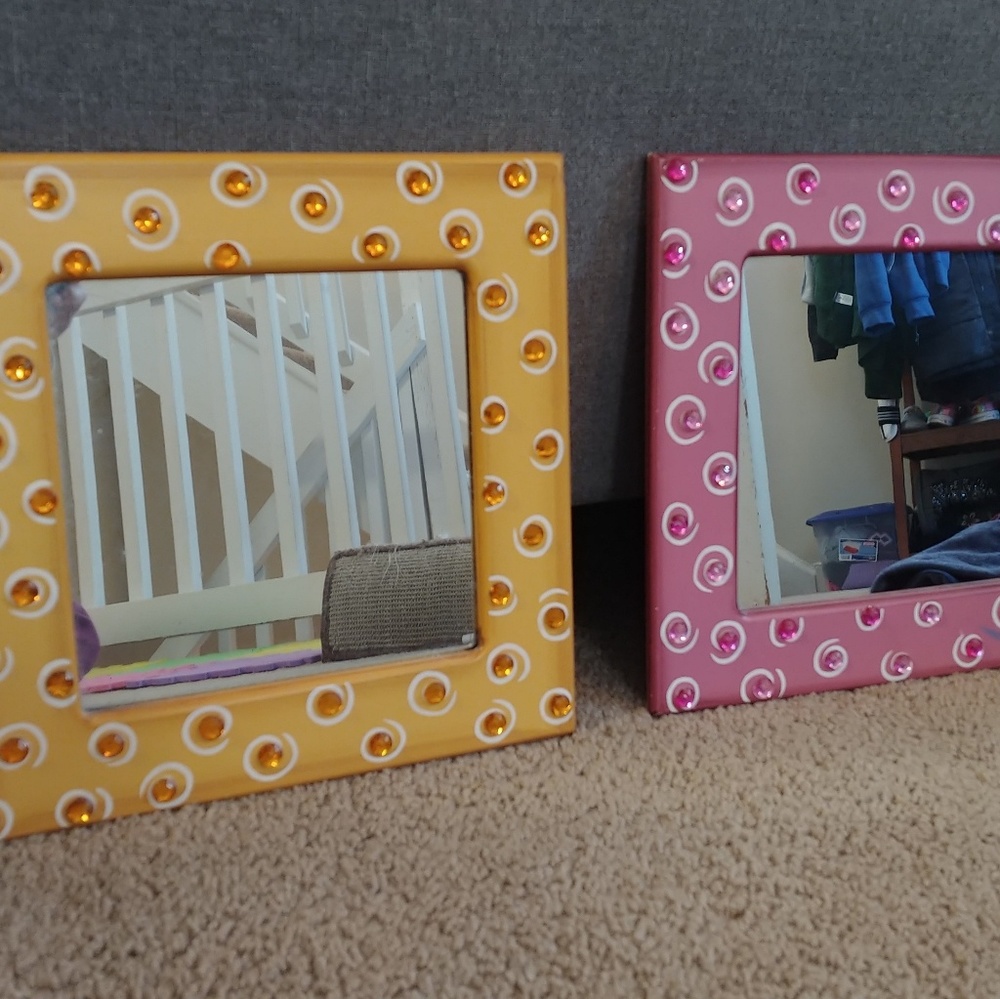 One pink and one yellow hand painted mirror